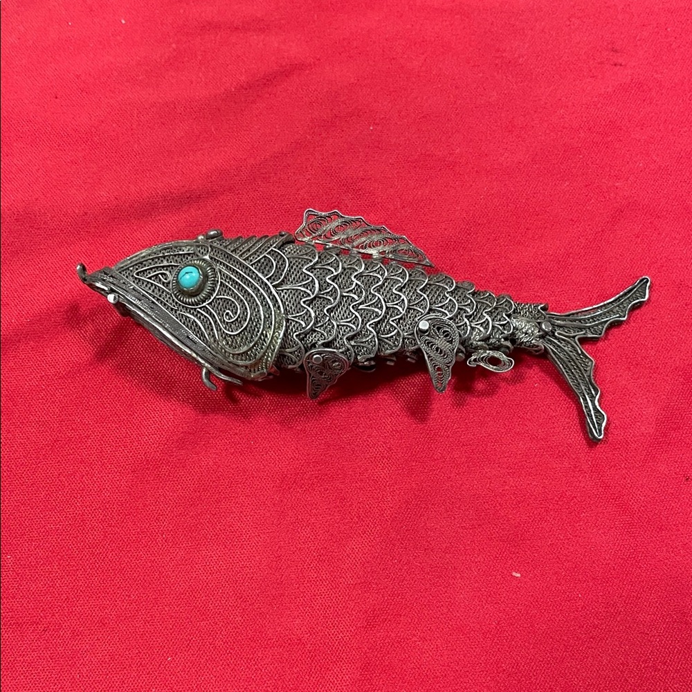 Intricate Silver Fish Necklace with Turquoise Detail.